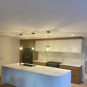 Another custom kitchen design with a curved corner island bar